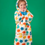 Frugi hooded fleece blanket in cosy cream with blue, orange and yellow star all-over print, worn by girl with hood up.