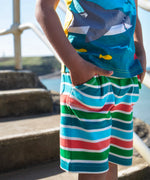Child wearing Frugi's Iori hotchpotch t-shirt showing the swimming sharks design 