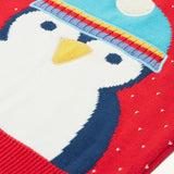 A closer look at the penguin character on the Caleb Character Knit Jumper - True Red/Penguin. The penguin has a navy blue and white body, yellow beak, and a light blue hat with white pom-pom on top 