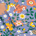 A closer look at the organic cotton Frugi Sofia Skater Dress - Rainforest Friends sleeves, and wildlife print. The image shows a happy tiger, rhino and flower/leaf prints