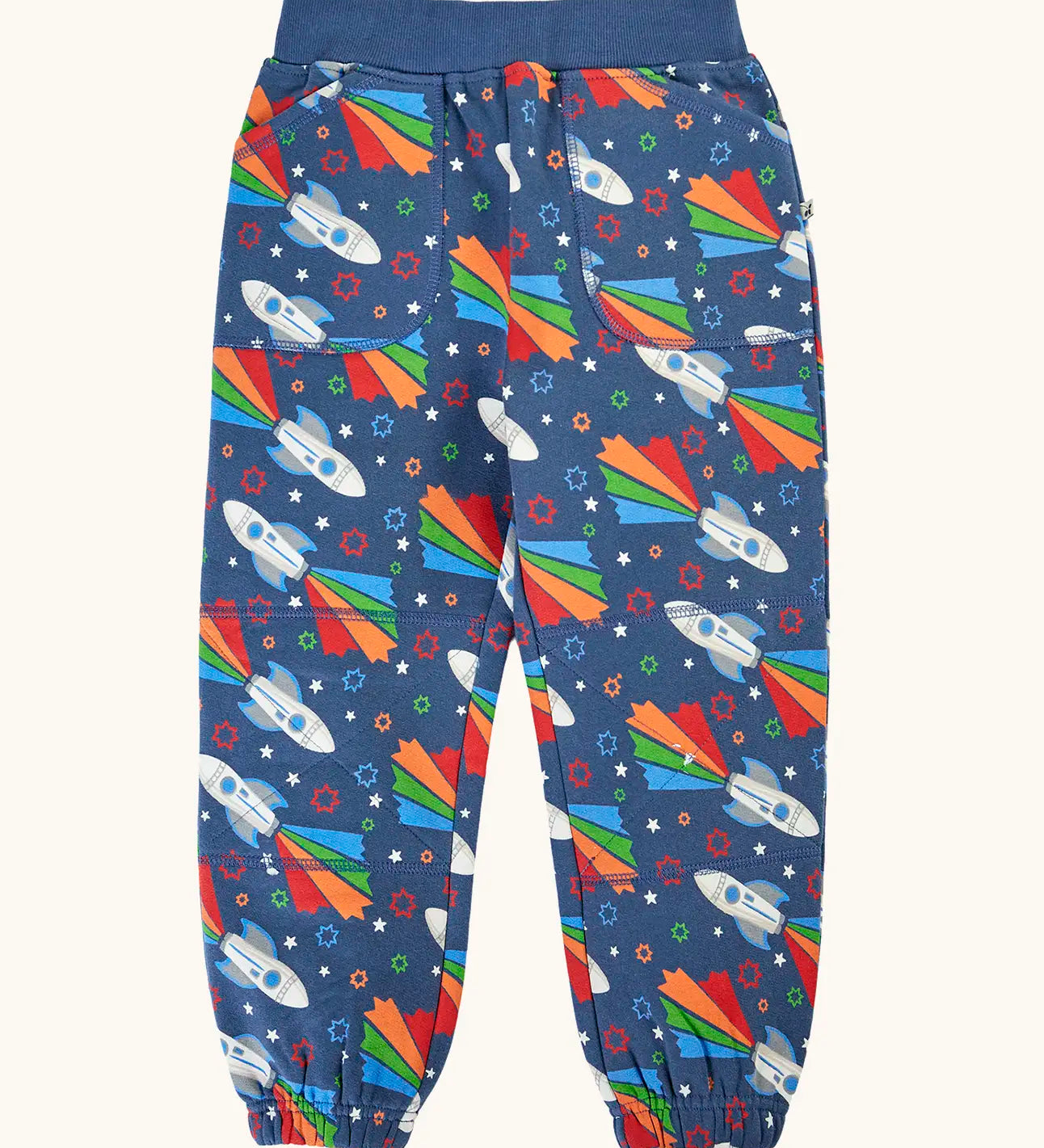 Frugi GOTS 100% organic cotton navy joggers with repeating space adventure rocket print with elasticated cuffs and waist band and side pockets