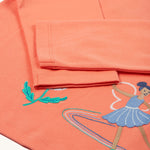The long sleeves on the Frugi Anna Applique Top - Cantaloupe/Fairy. The fairy applique is partially shown on the bottom right corner