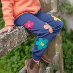 A closer look at the Frugi Perrin Parsnip Jogger - Navy Blue/Flowers, showing the flower applique details