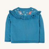 The back of the Frugi Romi Ruffle Cardigan - Deep Water/Fairies, showing the embroidered fairy's on the back of the ruffle collar