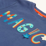 A closer look at the colourful, rainbow embroidered and applique magic lettering on the Frugi Adventure Applique Top - Navy Blue/Magic