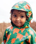 Small child wearing the Frugi waterproof green highland cow puddle buster all in one showing close up of fitted hood with extended brim