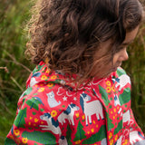 Child wearing the Frugi waterproof puddle buster coat in purrfect ponies showing the repeating cat and pony design inner