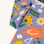 A closer look at the print on the Frugi Libby Printed Leggings - Rainforest Friends. The print has zebras, flamingos, parrots, and more wild friends print.