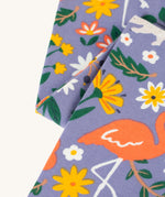 A closer look at the print on the Frugi Libby Printed Leggings - Rainforest Friends. The print has zebras, flamingos, parrots, and more wild friends print.