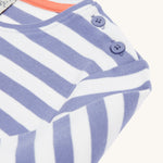 A closer look at the shoulder on the Frugi Louise Applique Top - Grape Stripe/Rainbow. The image shows the shoulder buttons, and the lilac and white stripes on the top