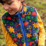 Child wearing the navy fleeced gilet with stars from the Frugi rambler 3 in 1 coat. Features a full length zip