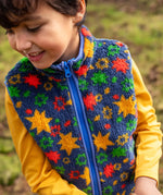 Child wearing the navy fleeced gilet with stars from the Frugi rambler 3 in 1 coat. Features a full length zip