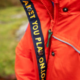 Child wearing the Frugi kids 3 in 1 rambler coat in fire upon a star showing the full length zip and popper fasteners