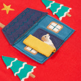 The open yellow door on the home applique. A dog is peeking from inside the door