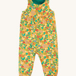 Frugi Lacey Reversible Dungaree - Iguana/Autumn Friends in a yellow floral rabbit and squirrel print
