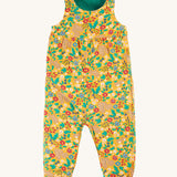 Frugi Lacey Reversible Dungaree - Iguana/Autumn Friends in a yellow floral rabbit and squirrel print