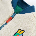 A closer look at the fleece side of the Frugi Robin Reversible Quilted Jacket - Teal/Moon