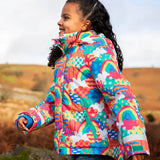 Child wearing the Frugi snow and ski coat in the fun frenzy design showing a zipped side pocket 