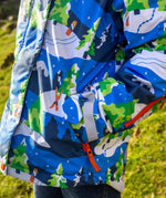 Child wearing the Frugi recycled polyester snow and ski coat in starry slopes showing a close up of the zipped pocket on the arm 