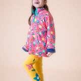 A child wearing the Frugi fun flowers snuggle fleece available at Babipur with the yellow Frugi fun flowers leggings
