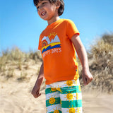 Child wearing Frugi's green and white striped shorts with repeating sun design  and a orange happy days applique tshirt