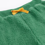 A close up of the yellow coloured waist tie on the Frugi ted fleece pull ups trousers in holly green