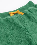 A close up of the yellow coloured waist tie on the Frugi ted fleece pull ups trousers in holly green