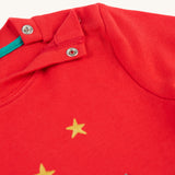 The popper fastenings on the shoulder of the Frugi Ira Interactive Applique Top - True Red/Winter Cottage