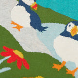 Frugi kids knitted dress showing a close up of the stitched puffins and flowers on organic cotton fabric