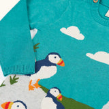 Frugi kids knitted dress in light blue laid flat showing a close up of the elasticated cuffs and button fasteners on the shoulder