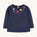 Frugi Laia Top - Starry Night/Space. A soft, organic cotton, navy blue, long sleeve top with light blue star pattern, with star and planet applique details around the neck collar
