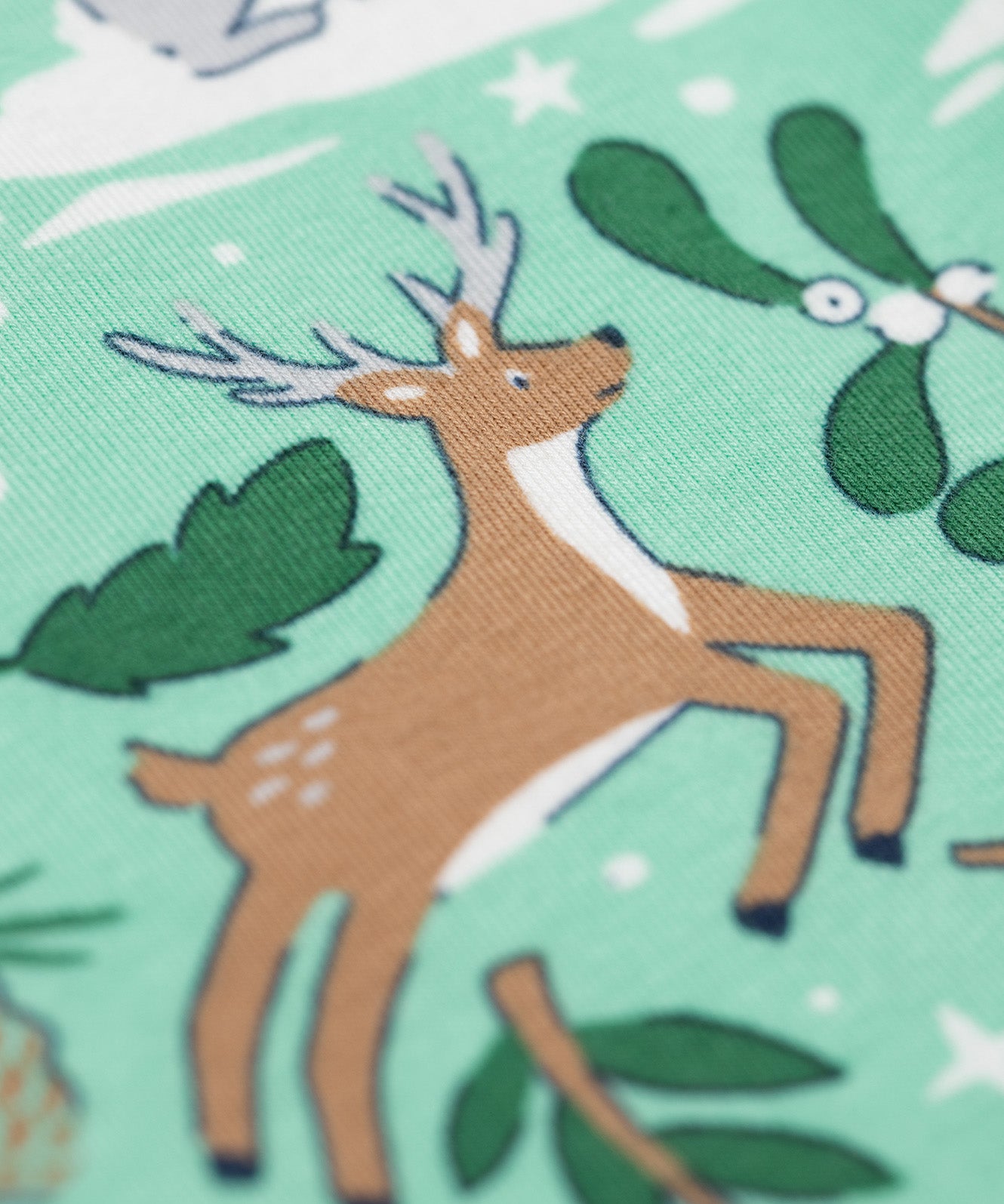 A close up of the reindeer design on the Frugi libby leggings in festive forest available at Babipur. 