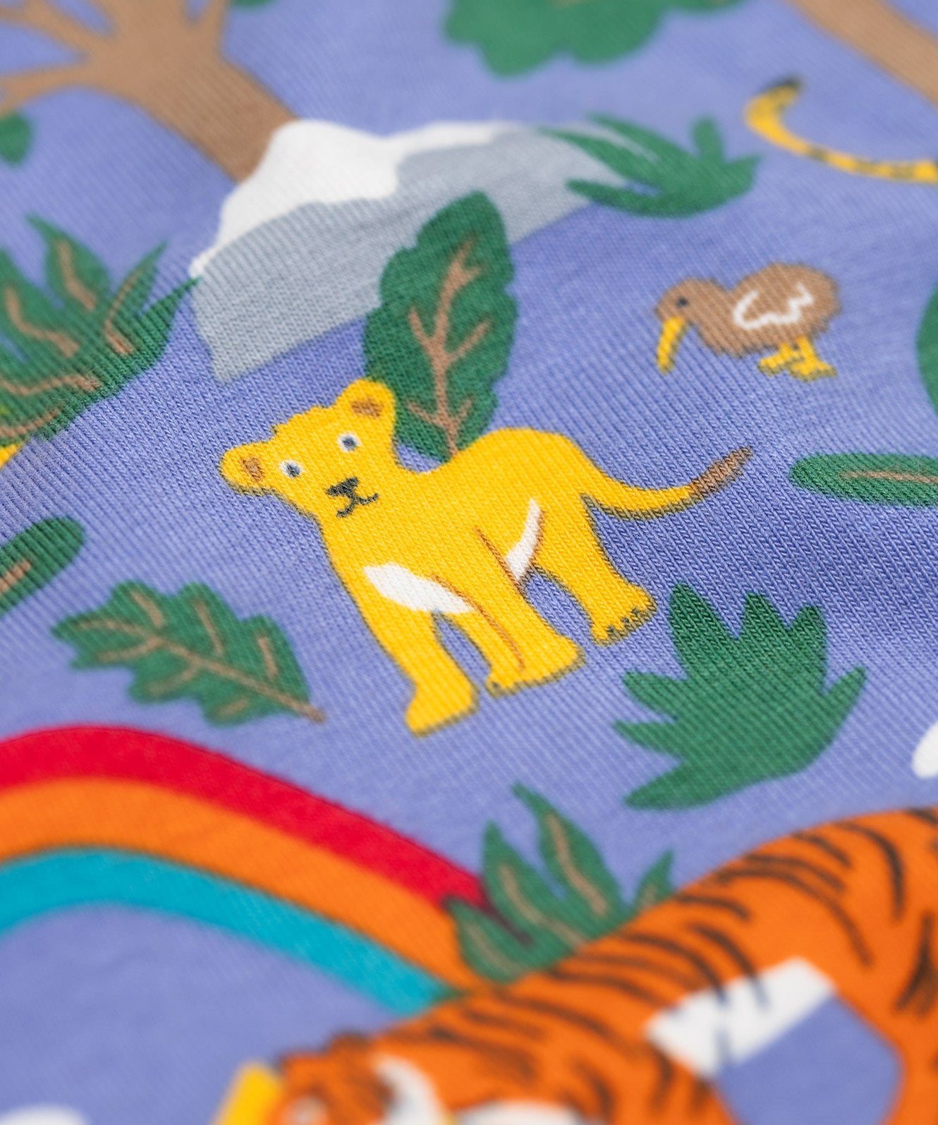 A close up of the lion design on the Frugi libby leggings in grape into the wild available at Babipur. 