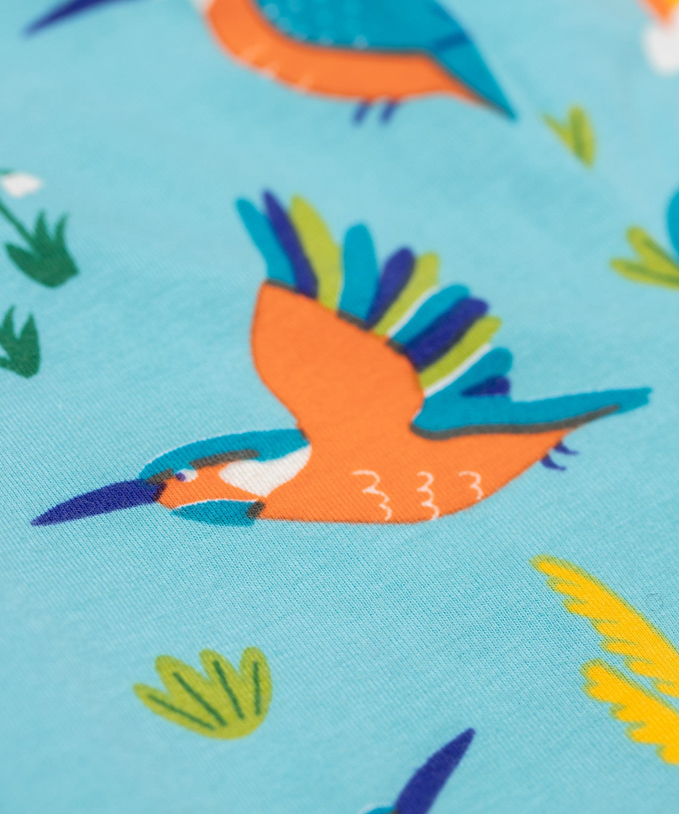 A close up of the flying kingfisher design on the Frugi libby leggings in kingfisher skies available at Babipur. 