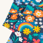 A closer look at the floral and rainbow print on the Frugi Libby Leggings - Winter Hedgerow