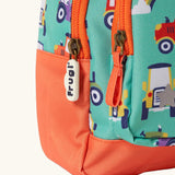 Frugi terrific tractors little adventures backpack showing a close up of the repeating tractor design and orange zip detail