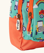 Frugi terrific tractors little adventures backpack showing a close up of the repeating tractor design and orange zip detail
