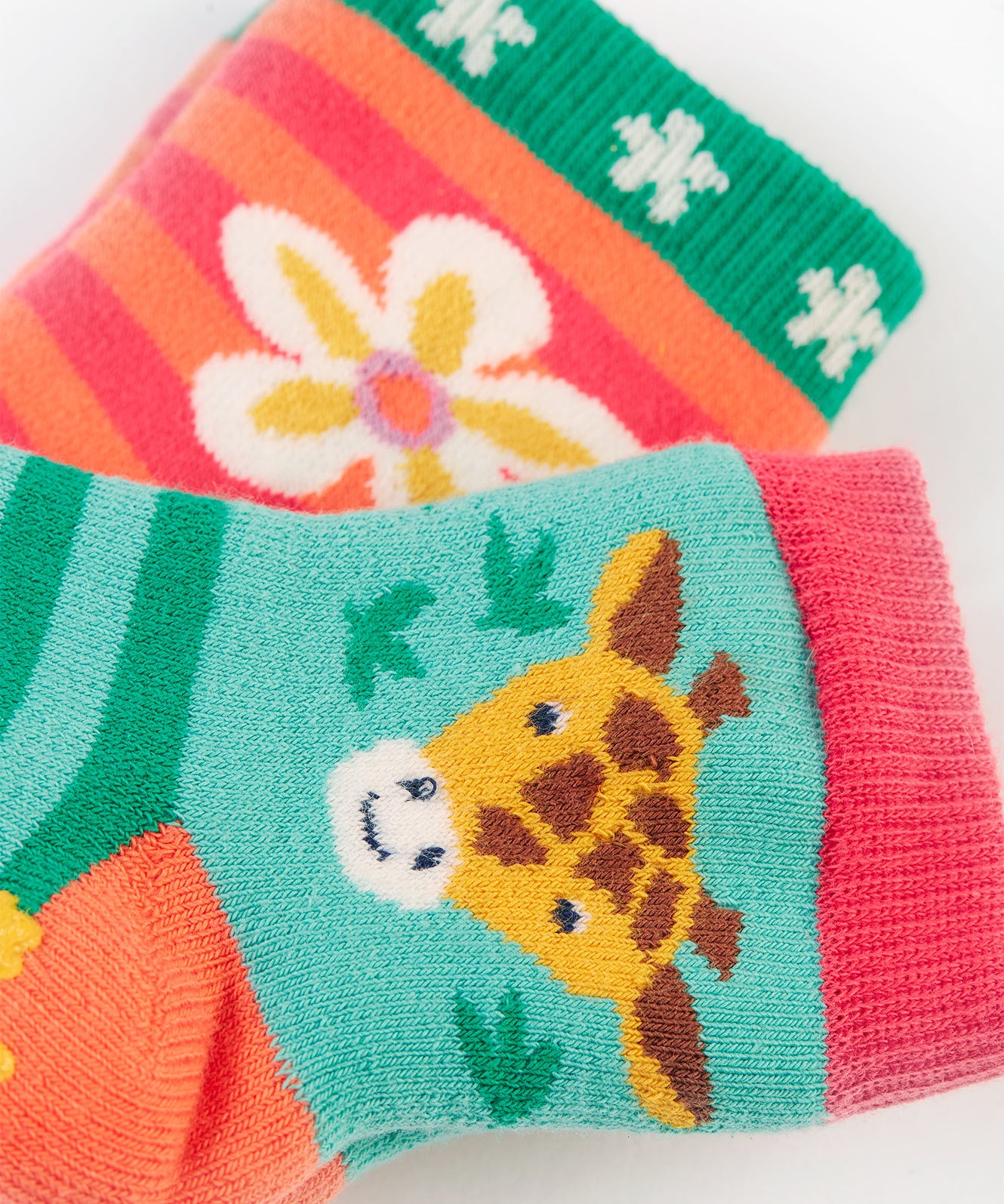 A closer look at the the giraffe and flower print on the Frugi Grippy Socks 2 Pack - Giraffe