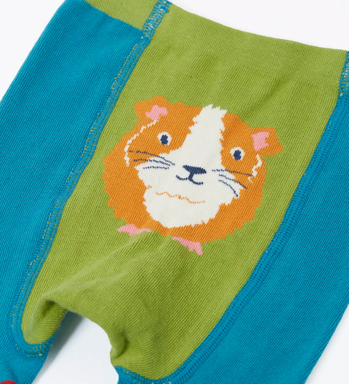 Frugi  knitted leggings in light blue showing a close up of a playful guinea pig design on the back on light blue organic cotton fabric