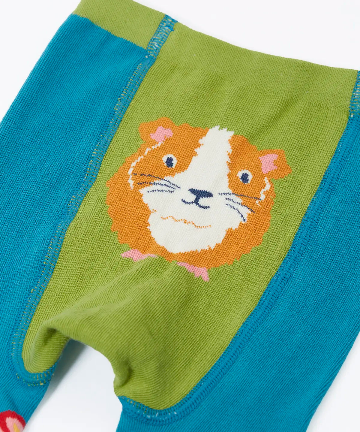 Frugi  knitted leggings in light blue showing a close up of a playful guinea pig design on the back on light blue organic cotton fabric
