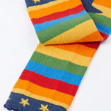 Frugi rainbow striped  knitted leggings laid flat showing a close up of the navy frilled leg cuffs