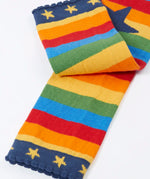 Frugi rainbow striped  knitted leggings laid flat showing a close up of the navy frilled leg cuffs