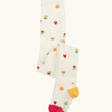 Frugi GOTS organic cotton little pointelle kids tights in soft white with a repeating floral and heart design. Features a pink toe and yellow heel 