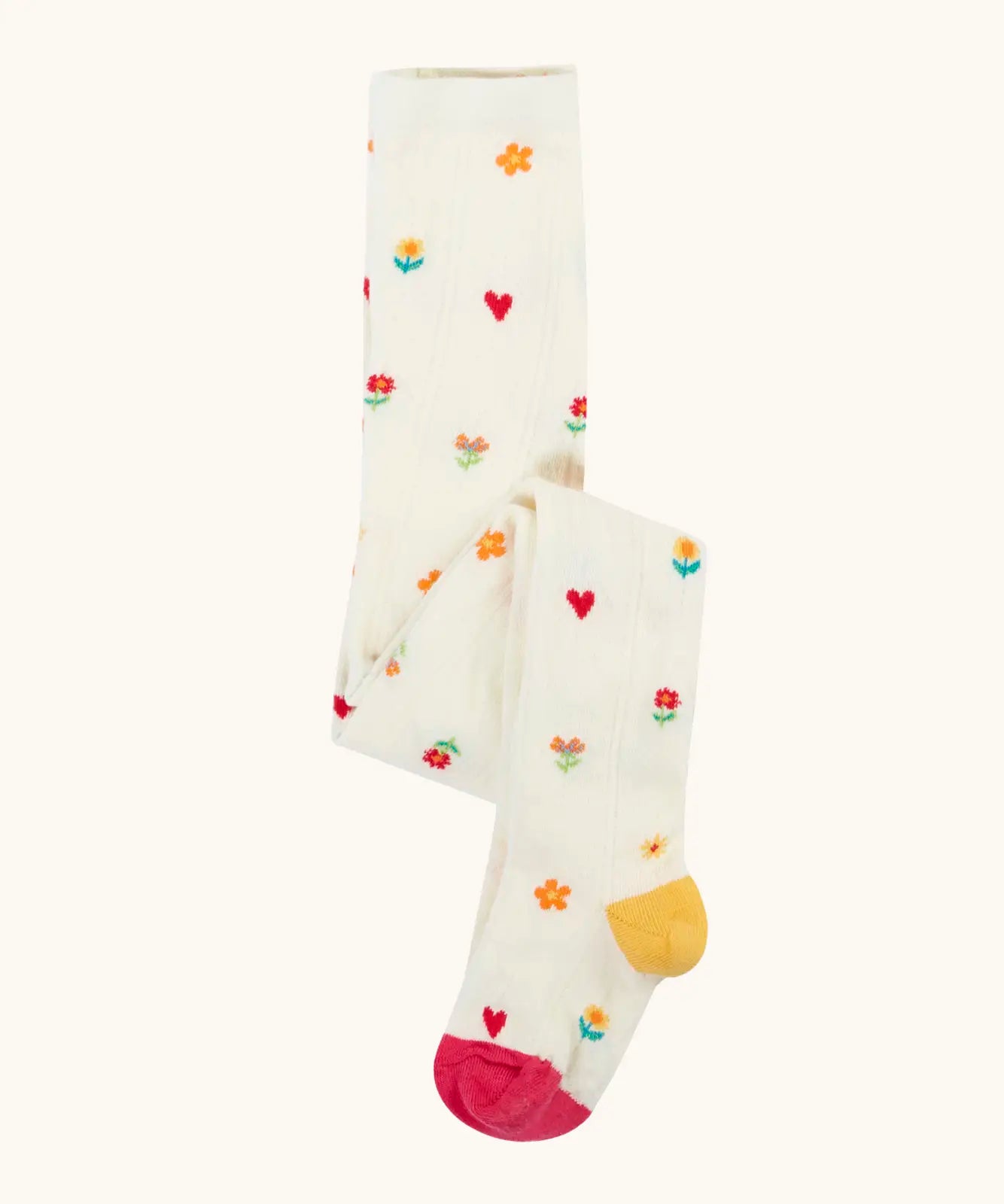 Frugi GOTS organic cotton little pointelle kids tights in soft white with a repeating floral and heart design. Features a pink toe and yellow heel 