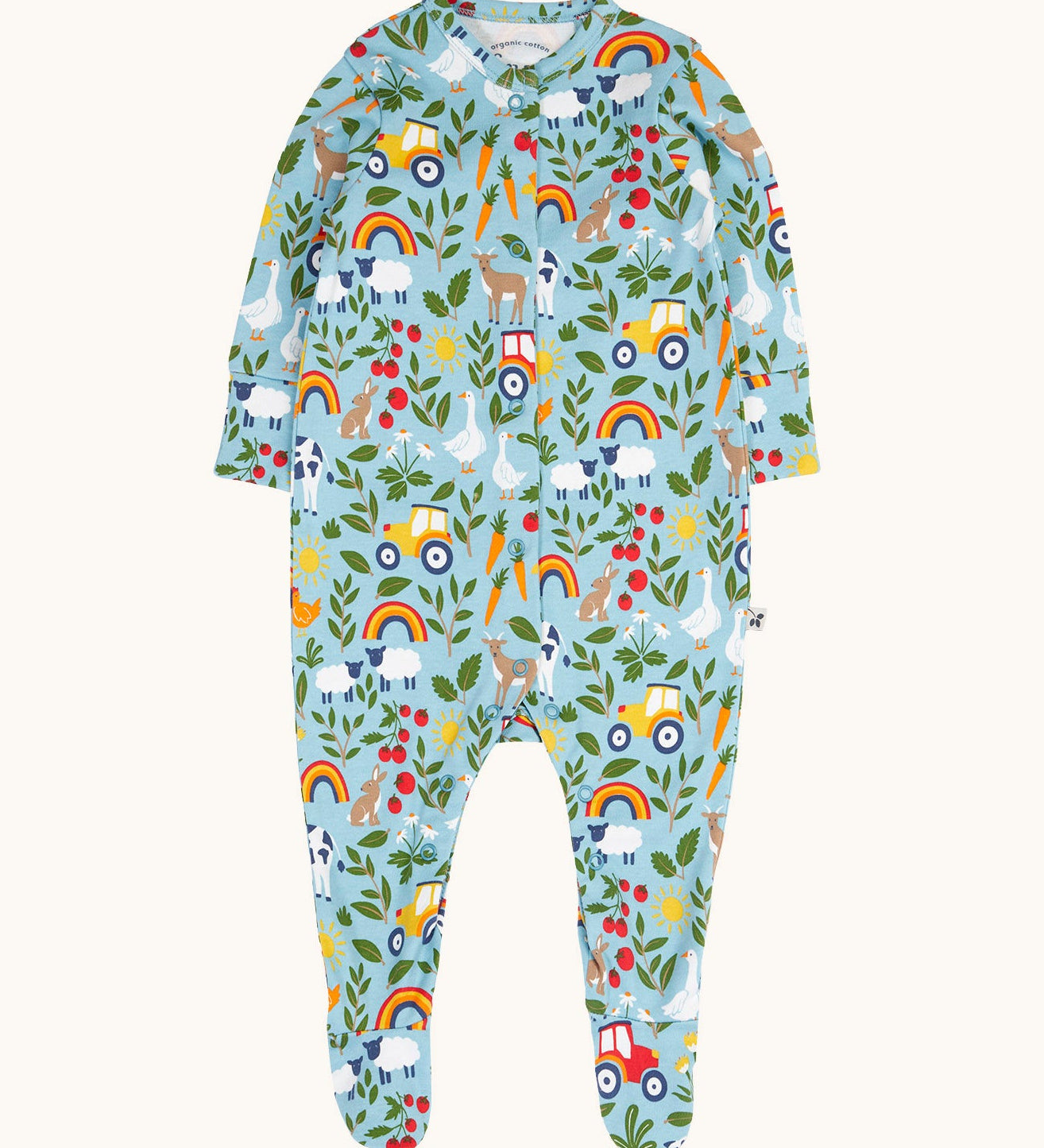 Frugi organic cotton footed babygrow. In light blue with a repeating farm themed print and a popper fastener from the neckline down the legs.