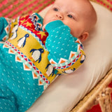 Baby wearing the Frugi GOTS 100% organic cotton knitted rompersuit in blue with a winter themed fairisle design on the upper half. Features elasticated cuffs and shoulder buttons for easy dressing.