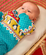 Baby wearing the Frugi GOTS 100% organic cotton knitted rompersuit in blue with a winter themed fairisle design on the upper half. Features elasticated cuffs and shoulder buttons for easy dressing.