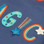 A closer look at the "Magic" lettering on the Frugi Adventure Applique Top - Navy Blue/Magic