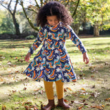 A child wearing the Frugi Magic Skies Organic Cotton Cosy Skater Dress. This party dress is a part of a wide range of organic cotton clothing for children available here at Babipur. 