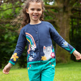 A child outside, wearing the Frugi Reva Knitted Cardigan - Navy Blue/Cat and green Frugi cord trousers